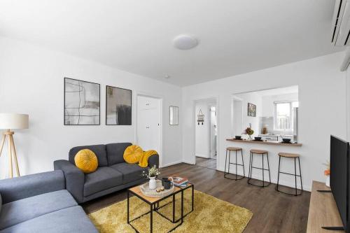 a living room with a couch and a table at Serene Coastal Haven in Melbourne