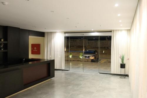 a living room with a television and a car in a garage at High Village Hotel in Al Namas