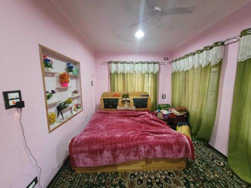 a bedroom with a bed with a red bedspread at OYO Home Aalim Homestay 