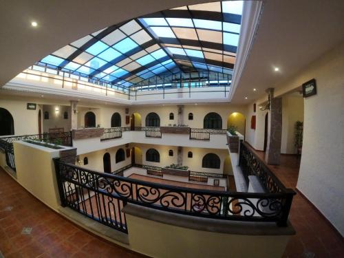 a large building with a glass ceiling and a staircase at HOTEL CASA DE LAS PALOMAS in Tonalá