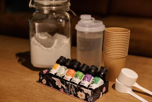 a group ofcolored markers on a table with a jar and plates at Ashibetsu Onsen Starlight Hotel in Ashibetsu