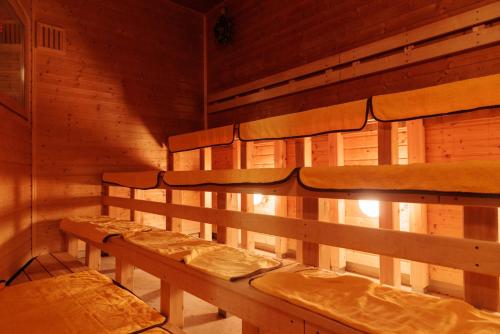 a row of beds in a wooden room at Ashibetsu Onsen Starlight Hotel in Ashibetsu