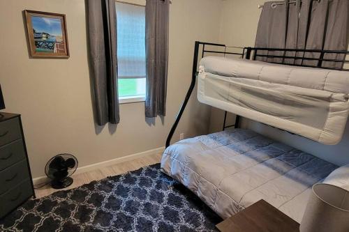 a bedroom with a bunk bed and a window at Newly renovated home with WIFI and ROKU TV in Brimley