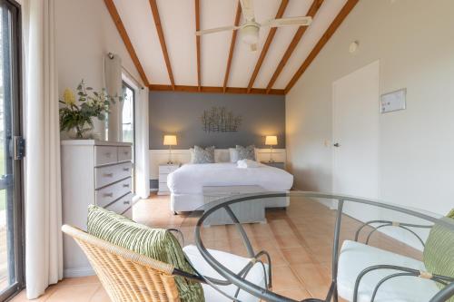 a bedroom with a bed and a glass table at Hunter Gleann Pty Ltd in Pokolbin