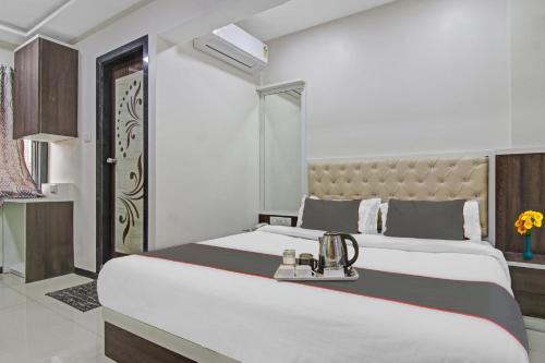 a bedroom with a large white bed with aigil at Collection O Hotel Raj Mahal in Turambhe