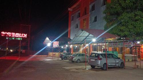 a group of cars parked in a parking lot at night at Kuber's Residency in Mahad