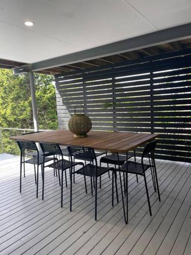 a wooden table and chairs on a deck at Unique 3 Bedroom House close to Merewether Beach in Merewether