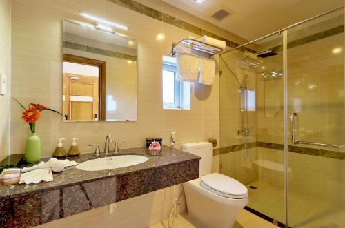 a bathroom with a toilet and a sink and a shower at Hang Masion Hotel & Apartment in Da Nang