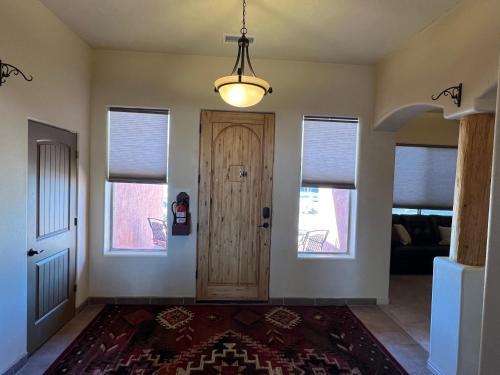 a hallway with a wooden door and windows at Spacious Home in Page