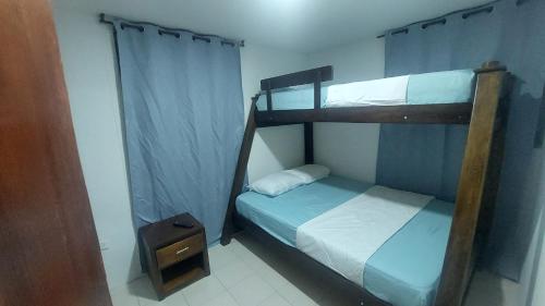 a bedroom with two bunk beds and a night stand at Posada N Seaflower Lodge 2 in San Andrés