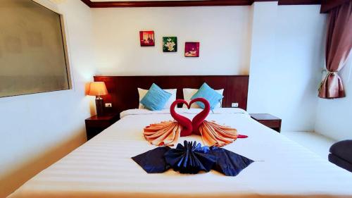 a bedroom with a bed with a red heart on it at Fruit Paradise in Patong Beach