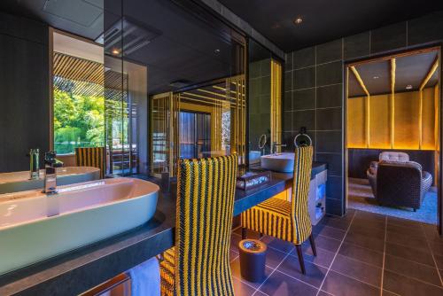 a bathroom with a tub and a sink at Kinnotake Sengokuhara(Adult Only) in Hakone