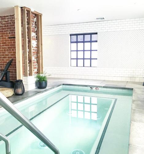 a swimming pool in a room with a brick wall at Family Laundry & Spa in Sacramento