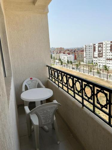 a balcony with a table and chairs and a view at Appartement in Tangier