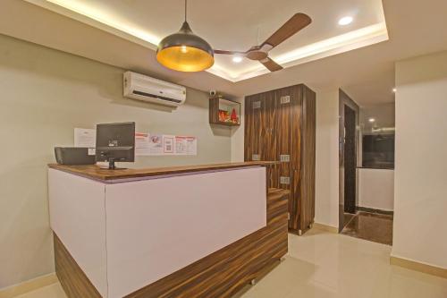 a reception desk in a room with a ceiling fan at Super Townhouse 733 Whiteridge Gachibowli Near AIG Hospital in Hyderabad