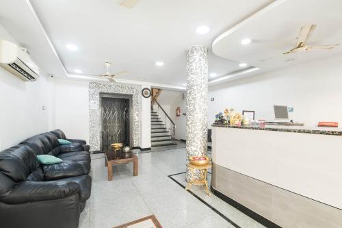 a living room with a couch and a bar at Hotel Aditya Grand in Guntūr