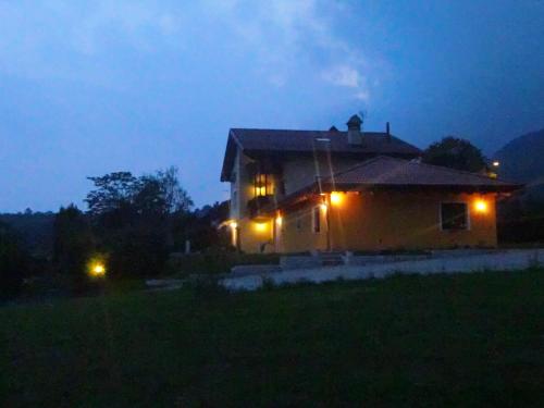 a house with its lights on at night at B&B Dolomitincanto in Cesiomaggiore