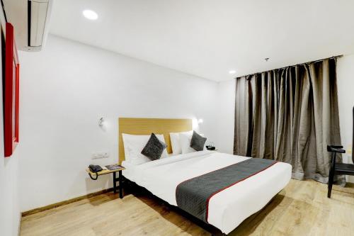 a hotel room with a bed and a window at Townhouse Rajyash Rise in Sarkhej