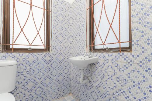 a bathroom with a sink and a toilet at RedDoorz near Pasar Lama Serang in Serang