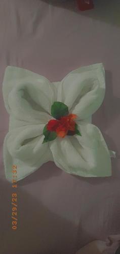 a white cake with a flower on top of it at Grace Garden Guesthouse by Eminence Ent in Ocho Rios