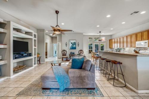 a living room with a couch and a bar at A Royal Oasis in the Desert with pool, spa and Epic Game Room! in Bermuda Dunes