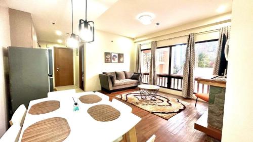 a living room with a table and a couch at BRENT RESIDENCES BAGUIO in Baguio