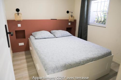 Posteľ alebo postele v izbe v ubytovaní Appartement cosy avec terrasse