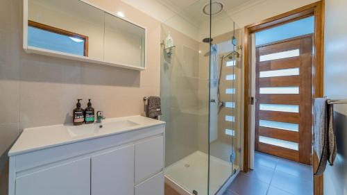a bathroom with a sink and a shower at Florida Trees Free Wifi Surf Side in Inverloch