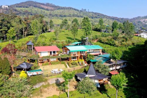 an aerial view of a house on a hill at De Rock Jungle Living Resort in Coonoor