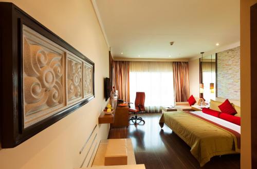 a hotel room with a bed and a couch at Vivanta Coimbatore in Coimbatore