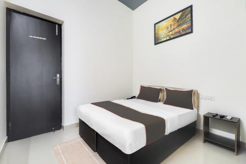 1 dormitorio con 1 cama con puerta negra en Hotel Mk Grand, en Patna