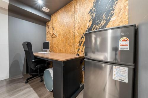 an office with a refrigerator and a desk with a computer at 27 Hotel in Anyang
