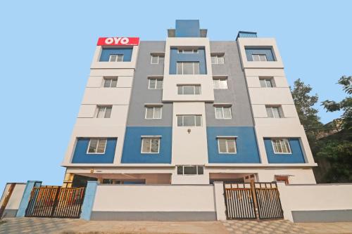 a building with a red sign on it at OYO City Holiday in Surūrnagar