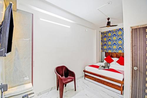 a bedroom with a bed and a chair at Flagship Diamond Regency Near Birla Mandir in Kolkata