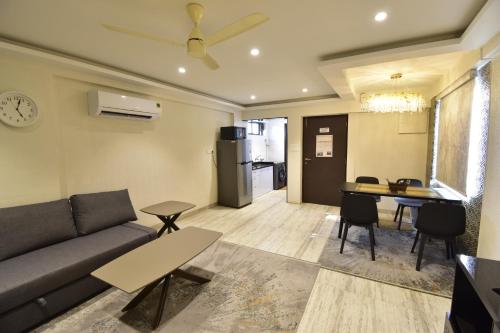 a living room with a couch and a table at Sarkar Chambers in Mumbai