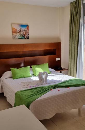 Postel nebo postele na pokoji v ubytování Hostal San Marcos