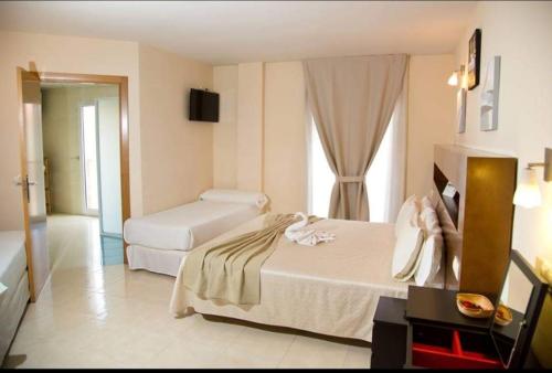 A bed or beds in a room at Hostal San Marcos