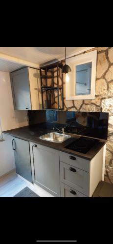 a kitchen with a sink and a counter top at Villa Volga in Jelsa