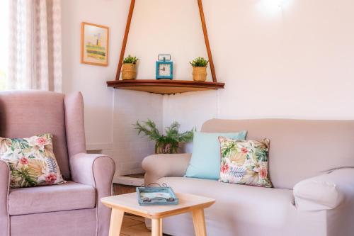 a living room with a couch and a table at Casa Can Pinyol in Cala Figuera