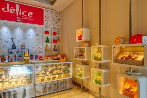 a bakery with a display case filled with food at Novotel Bengaluru Outer Ring Road in Bengaluru