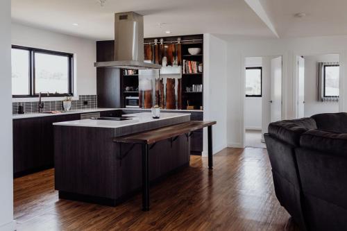 a kitchen with a island in the middle of a living room at Bayview Lodge - Views Views Views! in St Helens