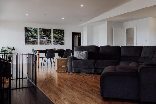 a living room with a couch and a table at Bayview Lodge - Views Views Views! in St Helens