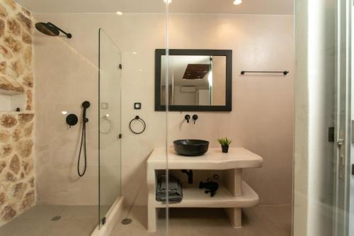 a bathroom with a sink and a glass shower at Naxos green Village hotel in Naxos Chora