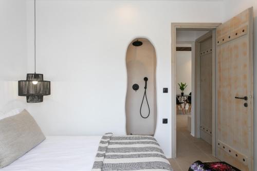 a bedroom with a surfboard in the corner of a room at Naxos green Village hotel in Naxos Chora