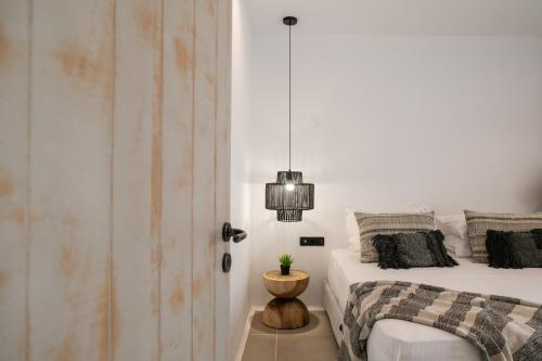 a bedroom with a bed and a potted plant at Naxos green Village hotel in Naxos Chora