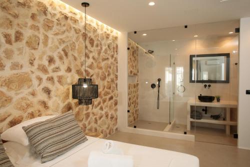 a bathroom with a shower and a bed in a room at Naxos Village hotel in Naxos Chora