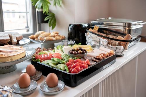 a buffet with vegetables and other foods on a counter at Malmo Historic Hotel in Chania Town