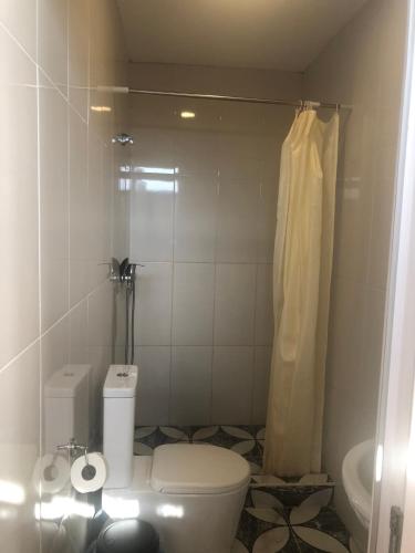 a small bathroom with a toilet and a shower at Sea in Shekvetili