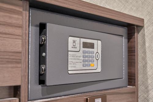 a microwave oven sitting on top of a cabinet at HOTEL VINE OSAKA KITAHAMA in Osaka