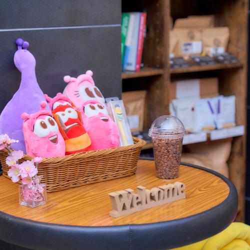 a table with a basket of hello kitty stuffed animals at HOTEL VINE OSAKA KITAHAMA in Osaka